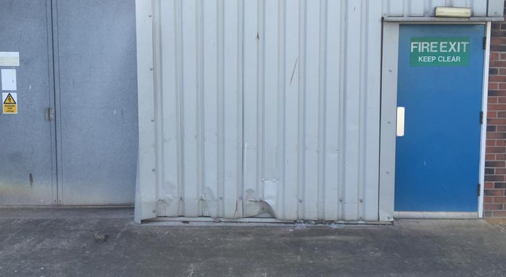 Damaged low level wall cladding.