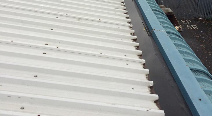 Industrial roofing in Birmingham with cut edge corrosion and old fixing points.