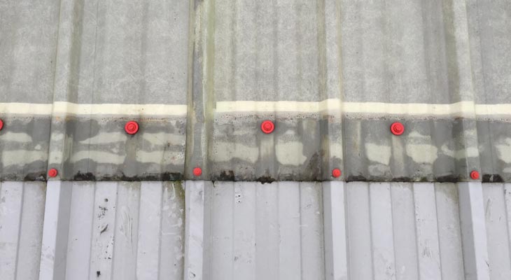 Close up photo of new poppy red fixings around rooflight edges