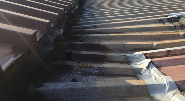 Blocked valley gutter causing severe roof sheet delamination