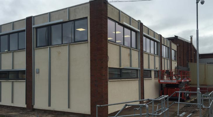 Side elevation galvanised steel grid system with powered access vehicle