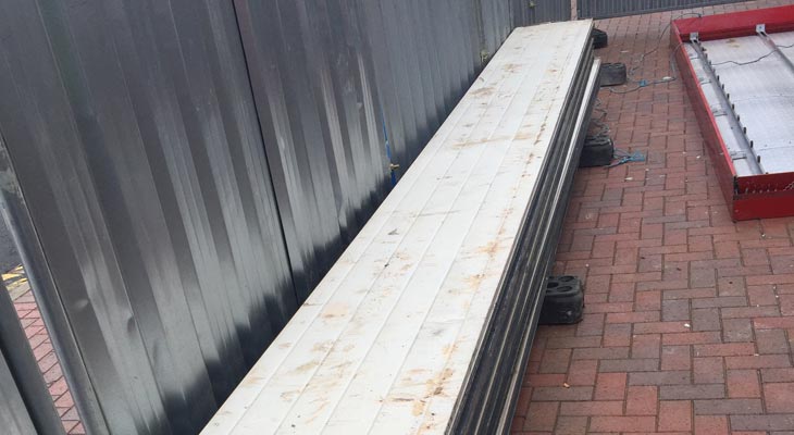 Floor stacked with old composite aluminium cladding panels and frame