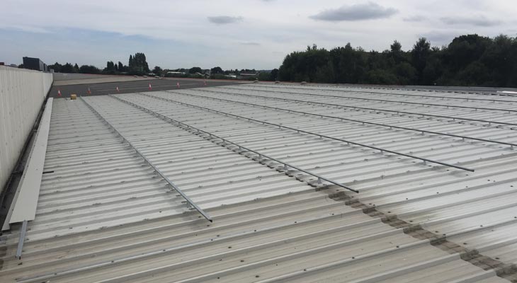 Eaves flashing installed to built up grid system at perimeter gutter