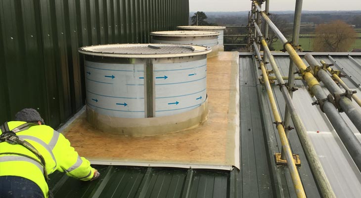 Coverclad GRP roofing specialists boarding out around cylinder flu stacks