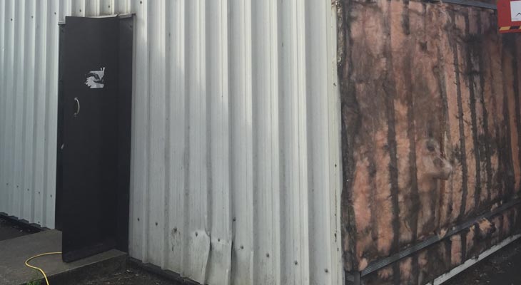 Wall cladding sheets removed exposing underlying insulation