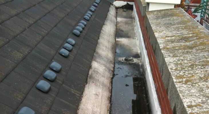 Old felt gutter in Leicester at retail store