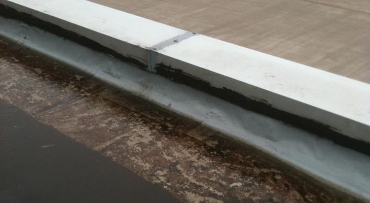 Failing historic repair to a parapet capping joint