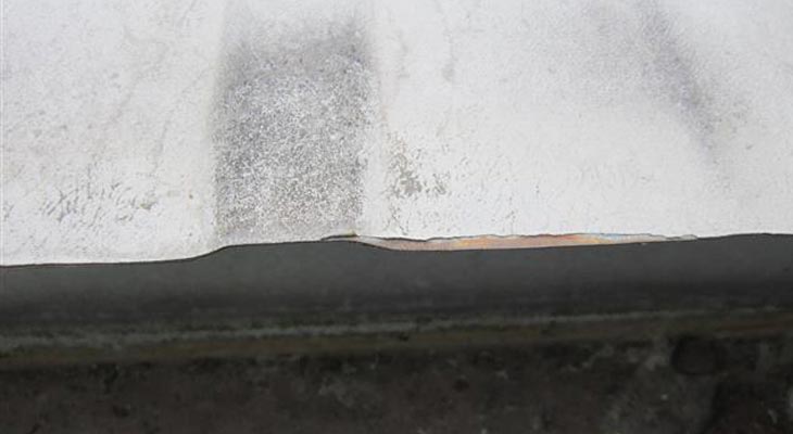 Close-up of cut edge corrosion to the roof eaves