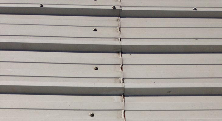 Cut edge corrosion to industrial roofing mid-laps