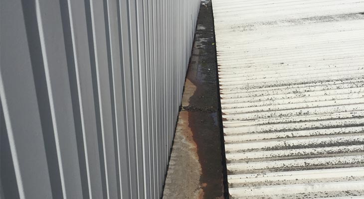 Industrial roof sheets suffering from moss and lichen build-up