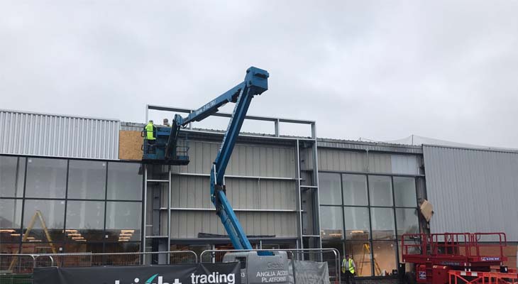 Cladding experts working from articulated boom