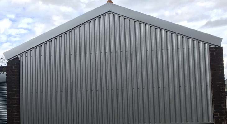 Wall cladding and barge flashing installed