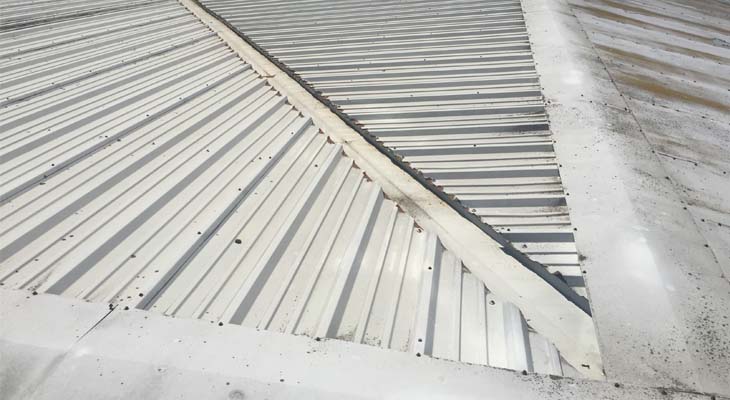 Hip valley gutter with cut edge corrosion