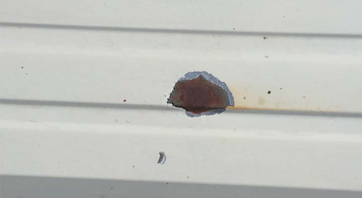 Spotted roof sheet delamination