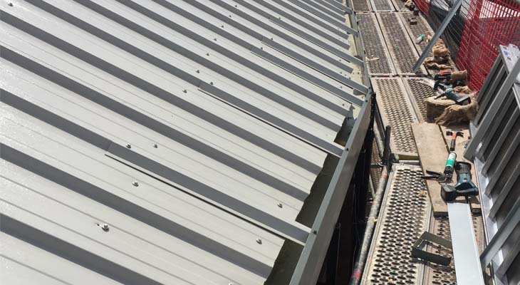 Roof level view of metal trimline gutter installed