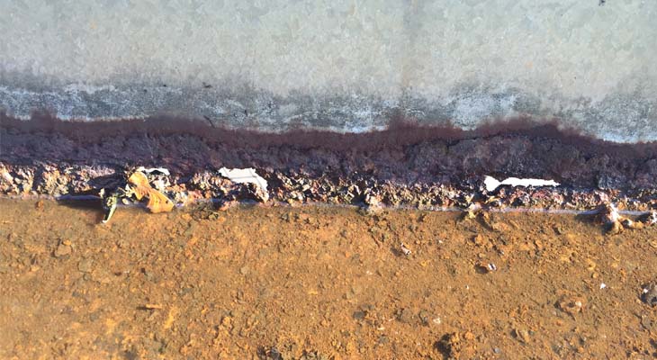 Gutter close-up with holes and poor structural integrity