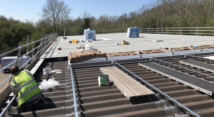 Grid bar system and overclad progressing across roof