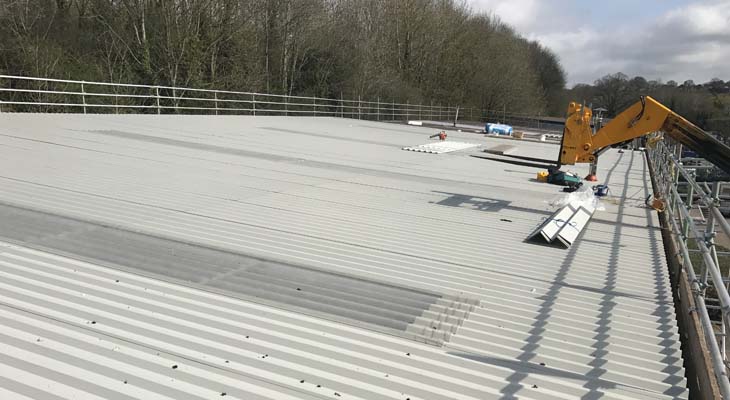 Telehandler delivering metal roof sheets to roof