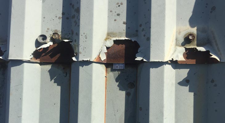 Metal ruler inserted into void of roof sheet midlap