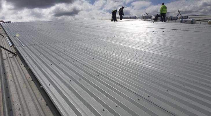 Coverclad operatives fixing down roof sheets